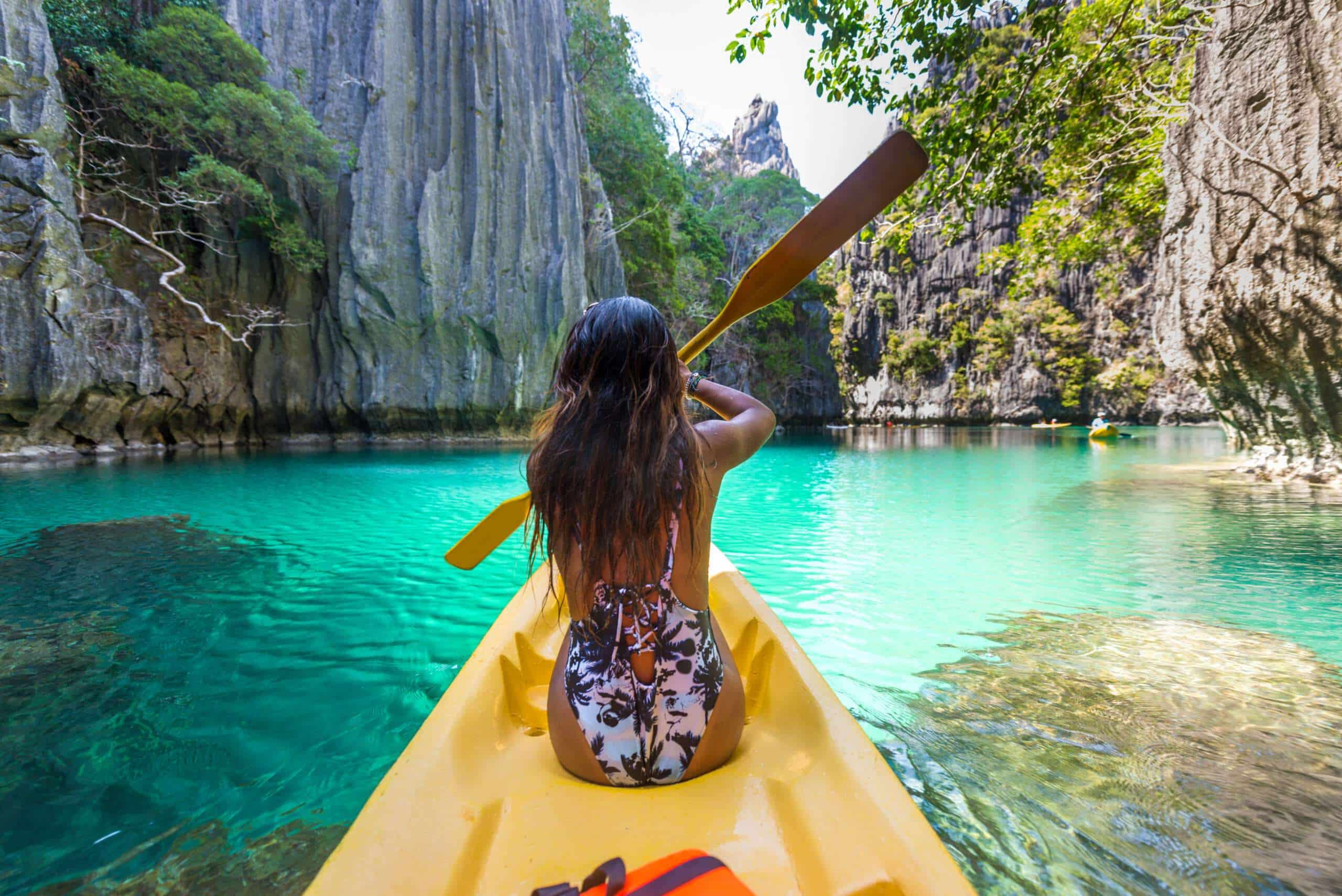 Woman kayaking in the Small Lagoon in El Nido, Palawan, Philippines - Travel blogger exploring south-east asia best places